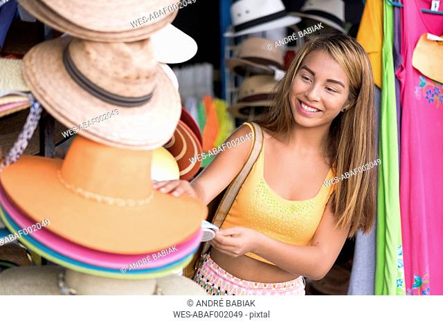 Happy teenager at a hat shop