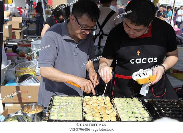 Chefs prepare Takoyaki (octopus balls) during the Taste of Asia Festival in Markham, Ontario, Canada. - MARKHAM, ONTARIO, CANADA, 29/06/2013