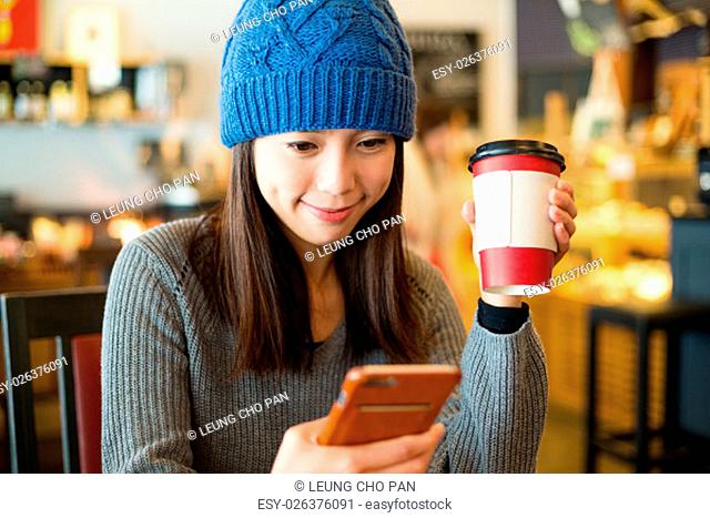 Woman use of smart phone in coffee shop