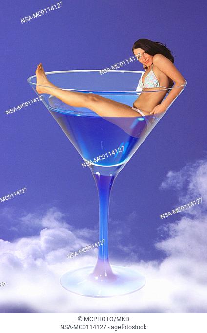 woman baths in cocktail glass