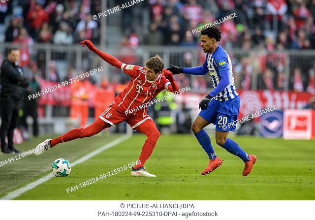 24 February 2018, Germany, Munich: German Bundesliga match between Bayern Munich and Hertha BSC in the Allianz Arena. Bayern's Thomas Mueller (l) and Hertha's...