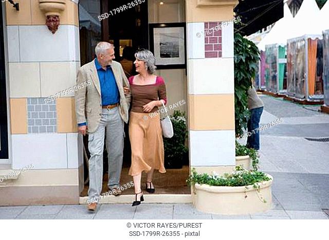 Mature couple walking in a shopping district
