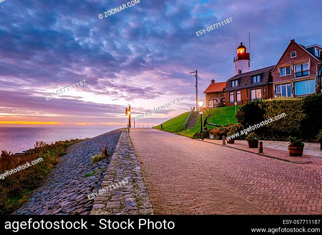 Urk village during sunset, Urk Flevoland Netherlands lighthouse and harbor lights during winter at the former Island of Urk Holland