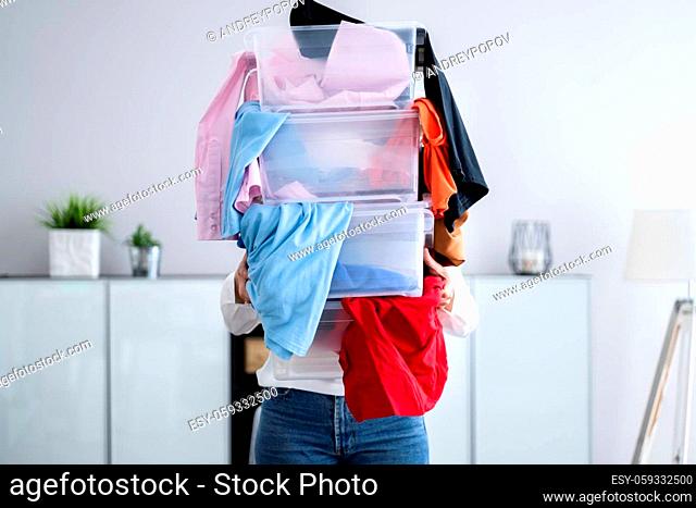 Woman Decluttering And Doing Laundry At Home