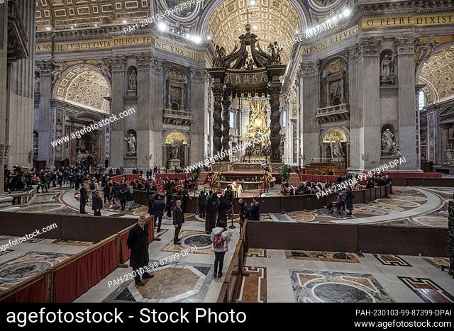 03 January 2023, Vatican, Vatikanstadt: The body of the late Pope Emeritus Benedict XVI is laid out in public in St. Peter's Basilica and believers can say...