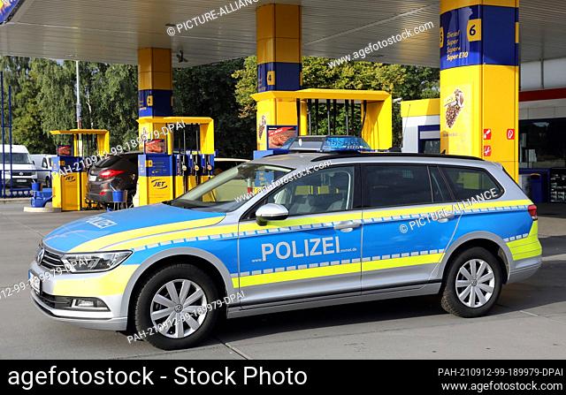 10 September 2021, Mecklenburg-Western Pomerania, Rostock: A police patrol car stands at a petrol station after refuelling