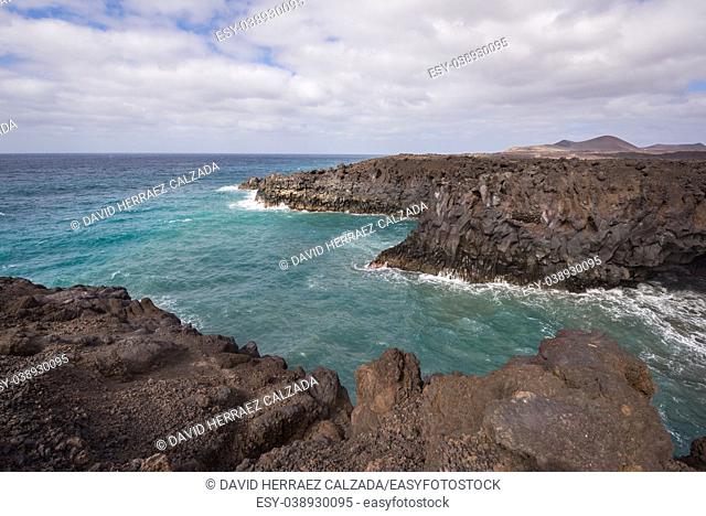 Lanzarote landscape. Los Hervideros coastline, lava caves, cliffs and wavy ocean. No people appears in the scene
