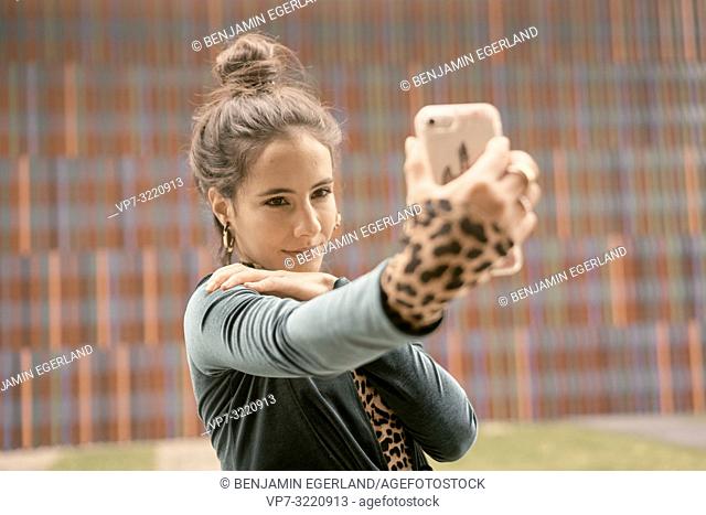 confident woman using smartphone, taking selfie, video conversation