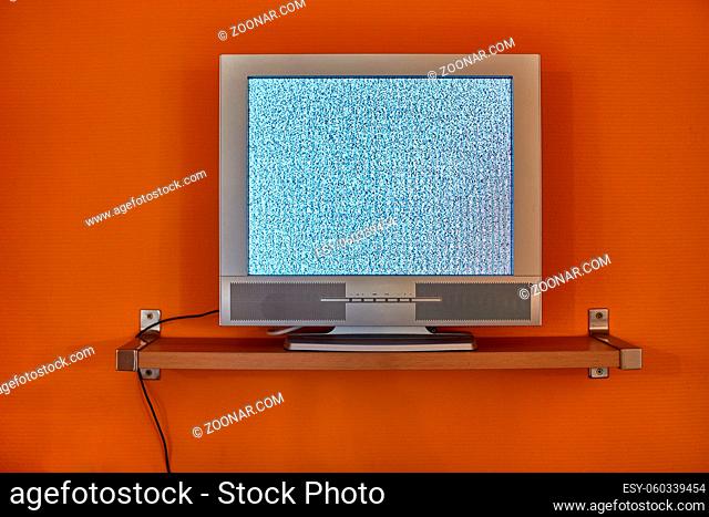 LCD TV against orange wall