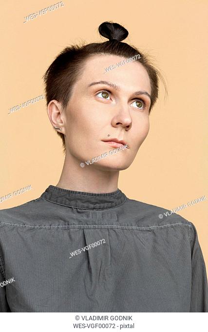 Portrait of serious woman with short hair and braid