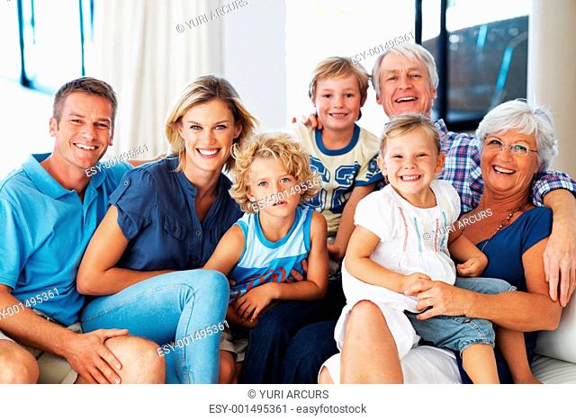 Portrait of happy multi generation family smiling together on couch