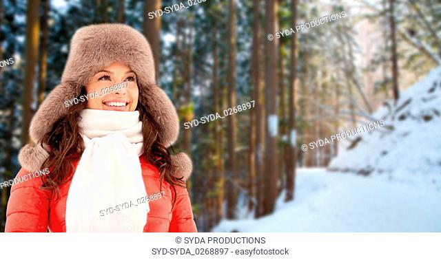 happy woman in winter fur hat outdoors