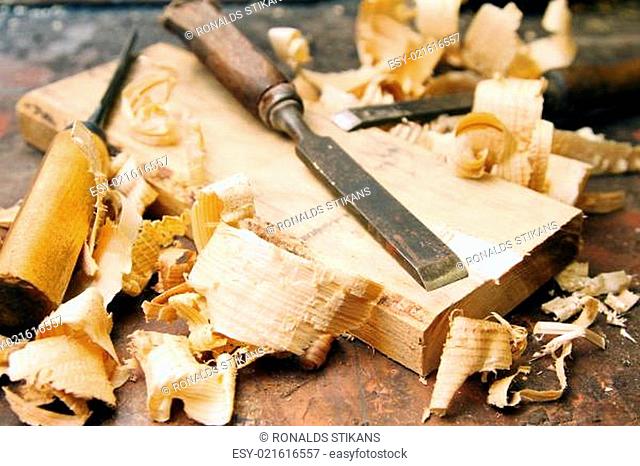 old wood chisels with shavings on the workbench