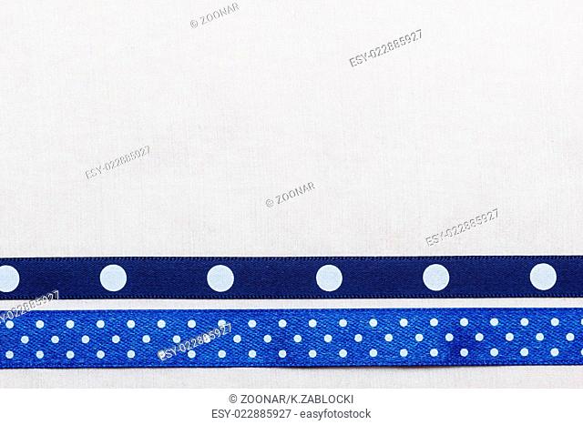 Dotted blue ribbon frame on white cloth