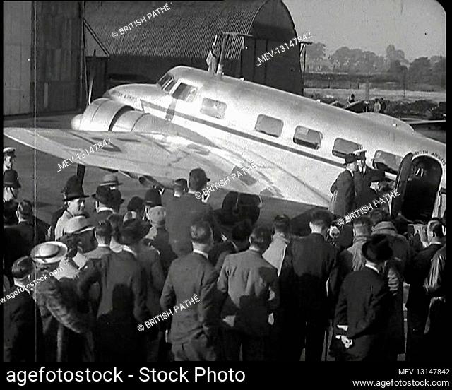 The British Prime Minister, Neville Chamberlain, Walking Towards A Lockheed Aeroplane Passing A Crowd of Journalists and Others Waiting To Hear Him Speak -...