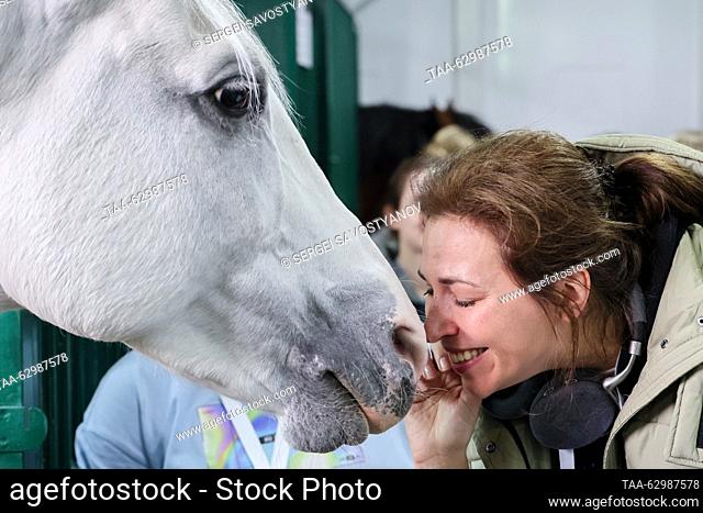 RUSSIA, MOSCOW - OCTOBER 4, 2023: A woman pets a horse at the 2023 Golden Autumn agricultural exhibition held at the Russian State Agrarian University – Moscow...