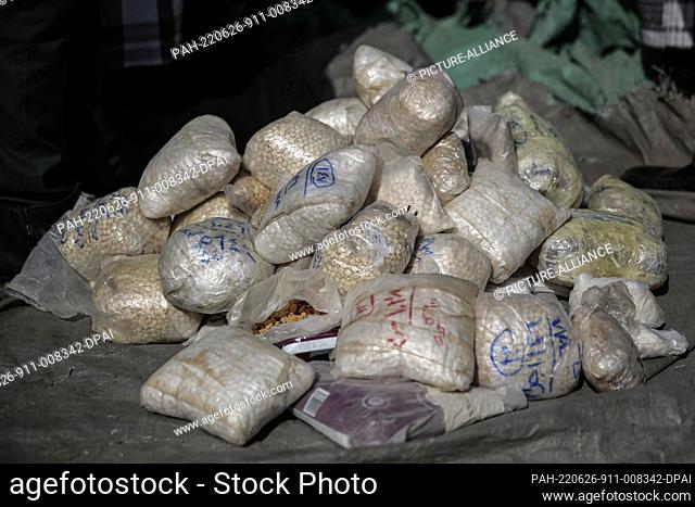 26 June 2022, Yemen, Sanaa: A general view of a pile of seized narcotics sacks before being set on fire during a destruction ceremony organized to mark the...