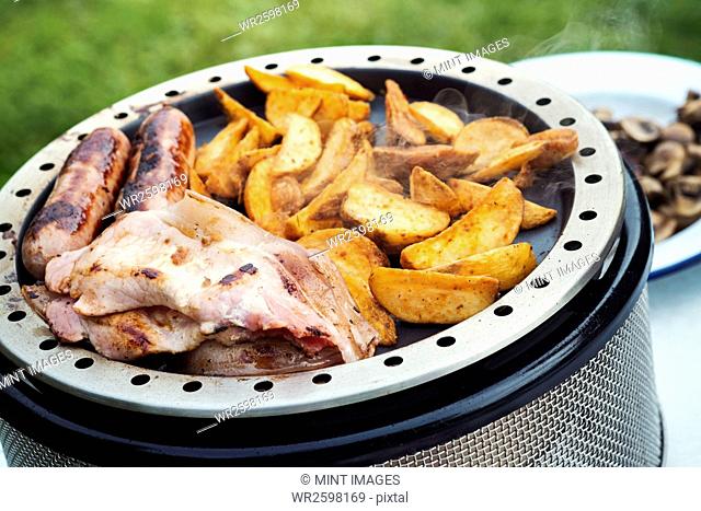 Close up of an English Breakfast being prepared on a camping stove