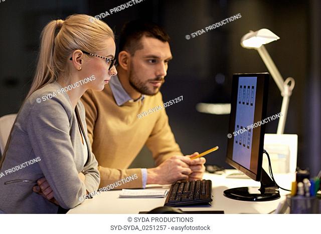 business team with computer working late at office