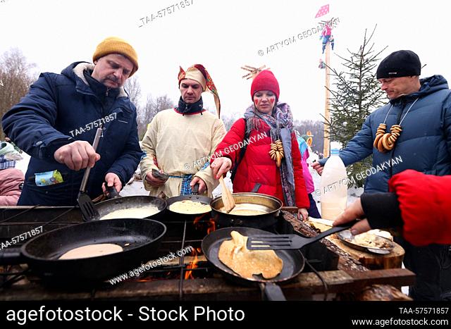 RUSSIA, MOSCOW REGION - FEBRUARY 26, 2023: People cook pancakes for the annual Bakshevskaya Maslyanitsa festival held by the Rozhdestvenka National History...