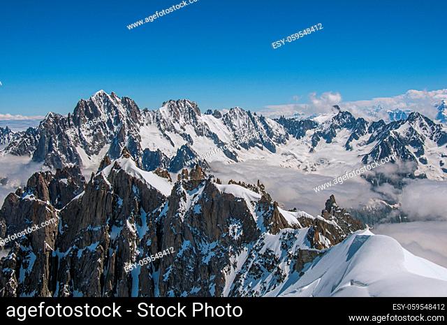 Snowy peaks and mountains in a sunny day, viewed from the Aiguille du Midi, near Chamonix. A famous ski resort located in Haute-Savoie Province