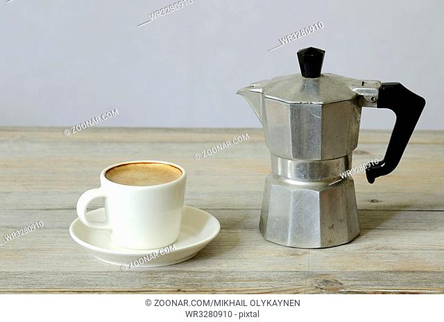 cup of coffee and percolator on wood