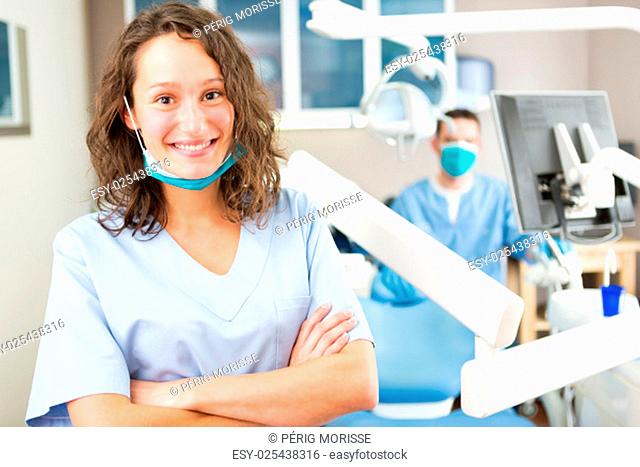 View of a young attractive dentist in his office
