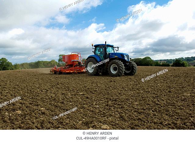 Tractor working in crop field