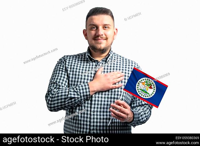 White guy holding a flag of Belize and holds his hand on his heart isolated on a white background With love to Belize
