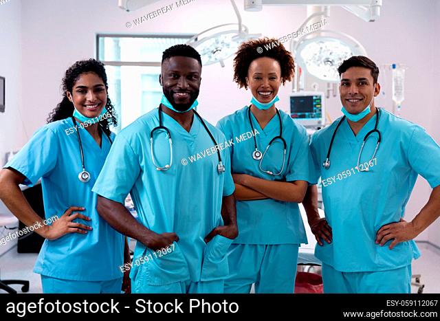 Portrait of smiling diverse surgeons wearing scrubs in operating theatre