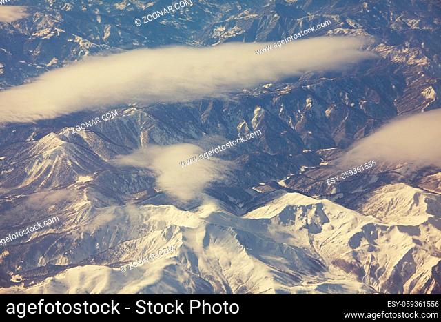 Aerial view from aircraft flying in high altitude. Landscape from above