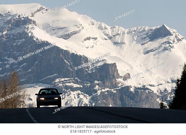 Canada, BC, Glacier National Park  Car on the crest of a hill on Highway 1 passing through the Rocky Mountains in spring