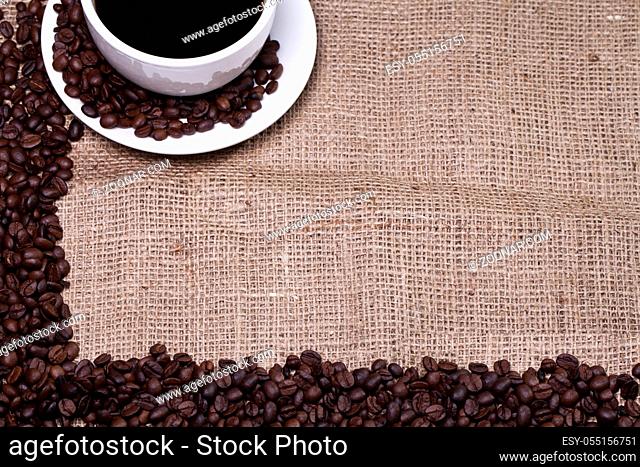 Cup of hot coffee over cloth sack