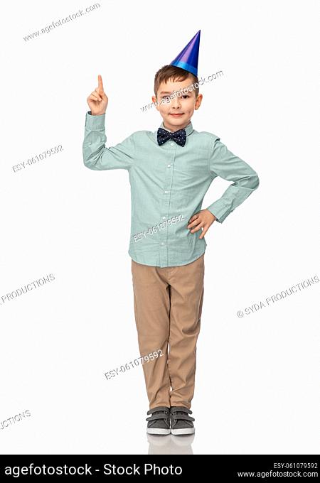 boy in birthday party hat pointing finger up