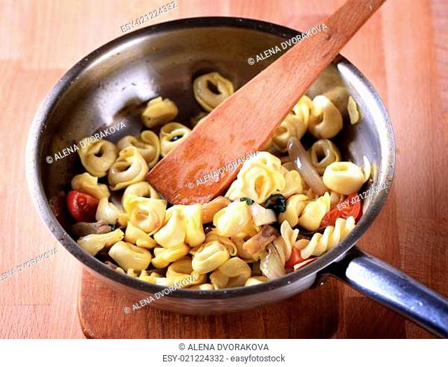 Preparing pasta dish