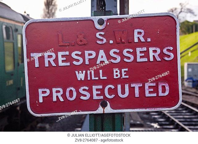 A railway station sign warning trespassers will be prosecuted