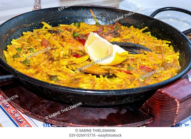 valencia paella with seafood and fresh lobster, calamari and mussels .