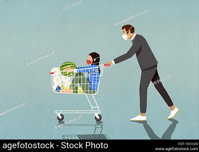 Man with protective face mask pushing daughter in shopping cart