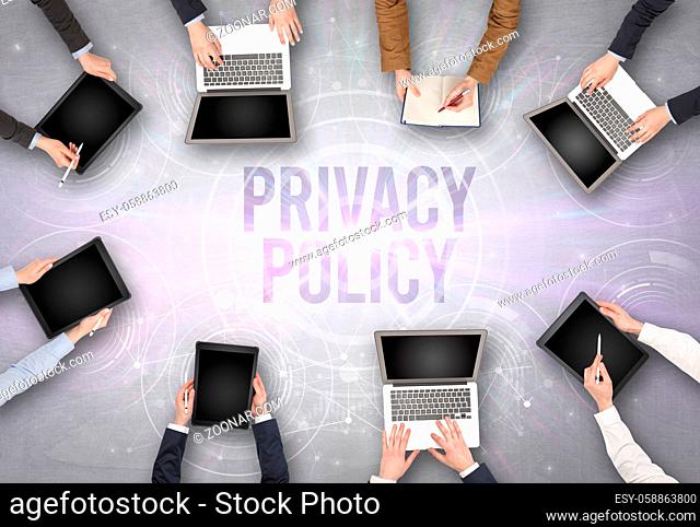 Group of people in front of a laptop with PRIVACY POLICY insciption, web security concept