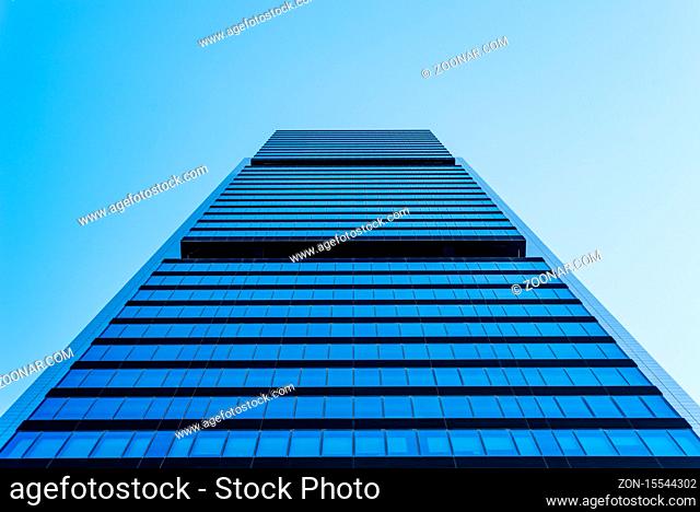 Madrid, Spain - May 10, 2020: Low angle view of office building in the city of Madrid against blue sky. Cuatro Torres financial district