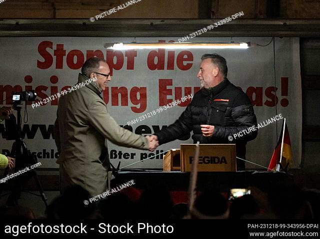 18 December 2023, Saxony, Dresden: Jörg Urban (l), Chairman of the AfD Saxony, is greeted on stage by the movement's founder, Lutz Bachmann
