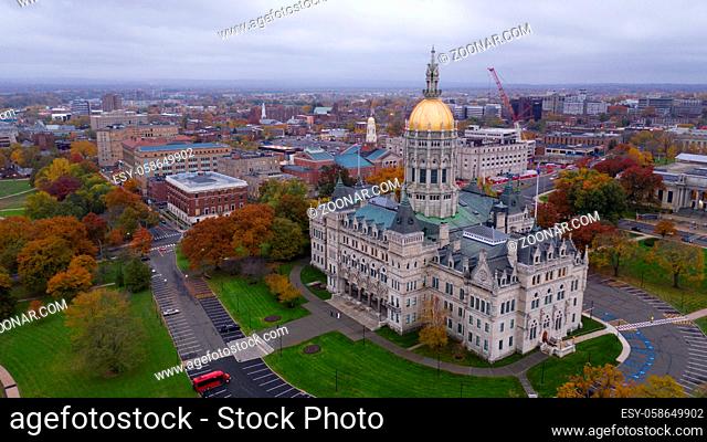 An aerial view focusing on the Connecticut State House with blazing fall color in the trees around Hartford