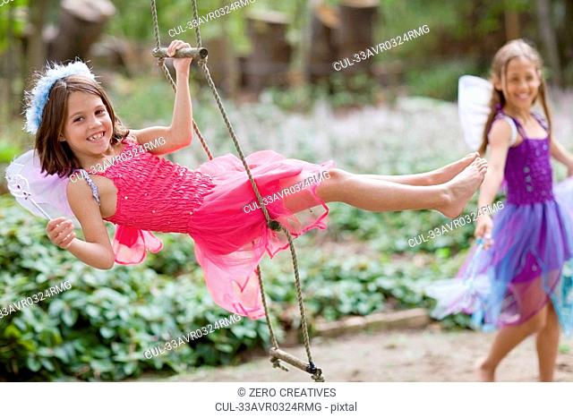 Girl climbing rope ladder in costume
