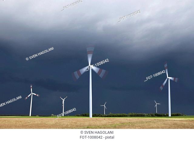 Wind turbines spinning in a field