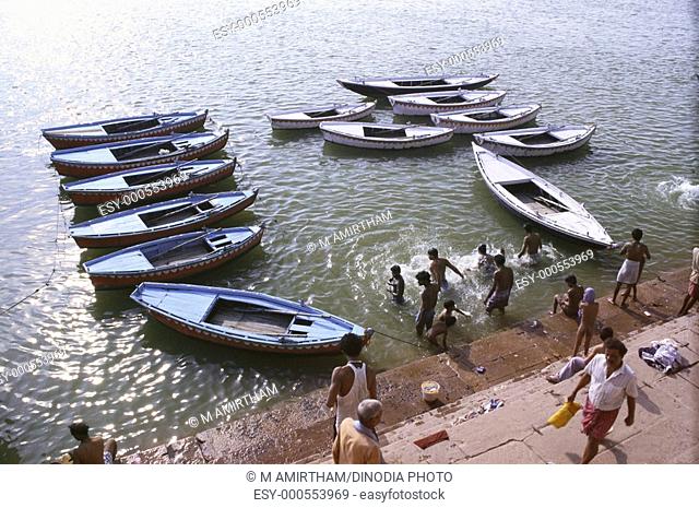 Boats along bathing ghat of river , Varanasi , Uttar Pradesh , India