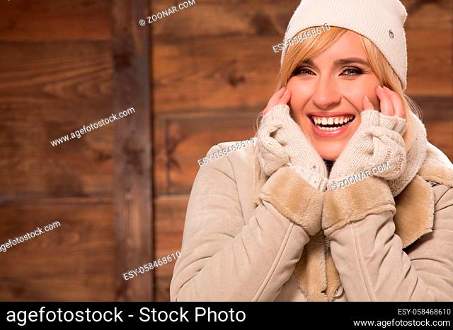 Smiling young woman in wear for cold weather