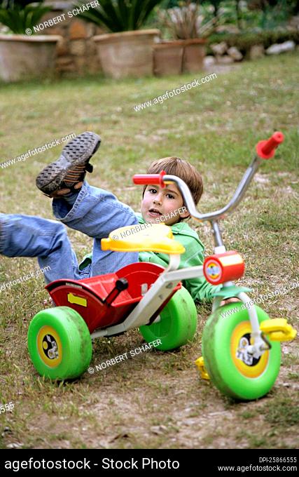 Boy Falling Off Tricycle