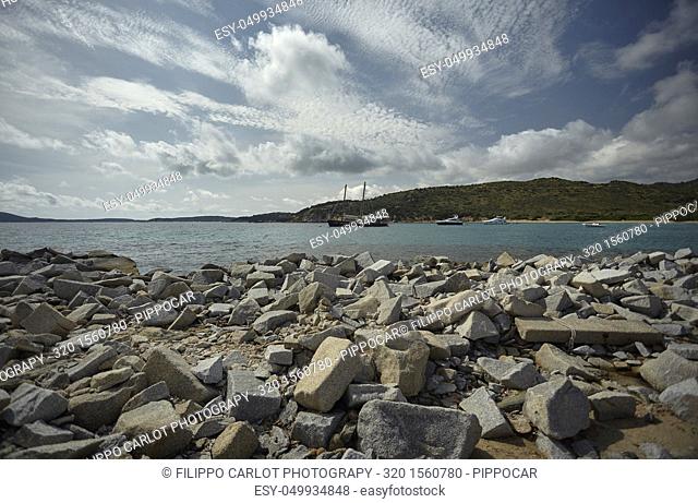 Panorama of Punta Molentis beach in the south of Sardinia, with the rocky beach and some boats moored a little further on
