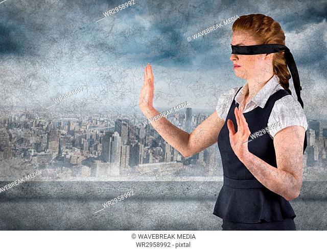 Business woman blindfolded with grunge overlay against skyline with grey clouds
