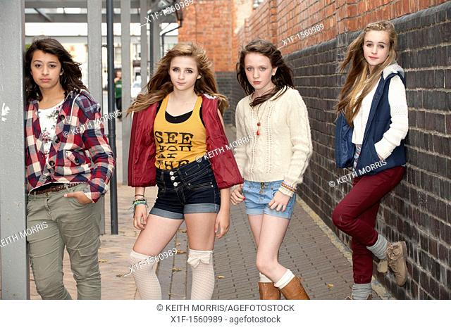 A group of 13 year old teenage girls, moody with attitude, UK